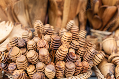 Fototapeta Naklejka Na Ścianę i Meble -  Traditional Cretan handmade olive wood honey dipper objects made of olive wood, souvenir market store.