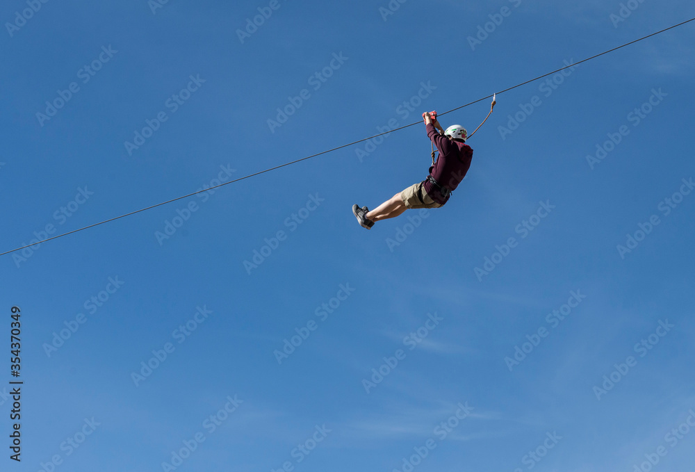 People on the mountains enjoying a zip line in La Rumorosa, Baja California. MEXICO, Extreme sports concept People on the mountains enjoying a zip line in La Rumorosa, Baja California. MEXICO, Extreme sports concept