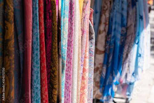 Multicolored сolorful scarfs in a tourist souvenir store, textile market.