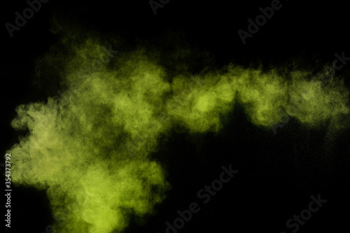 Light green powder explosion on black background. Colored powder cloud. Colorful dust explode. Paint Holi.