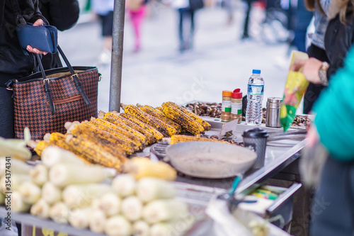 Yellow grill ears of corn on stalls. street fast food
