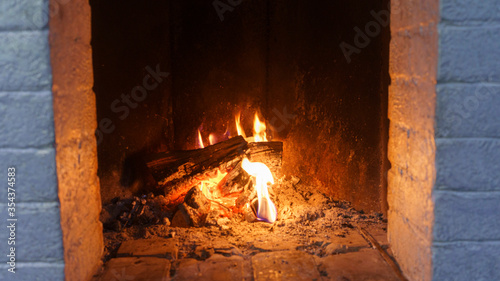 Burning logs in a cozy fireplace. Fire background.