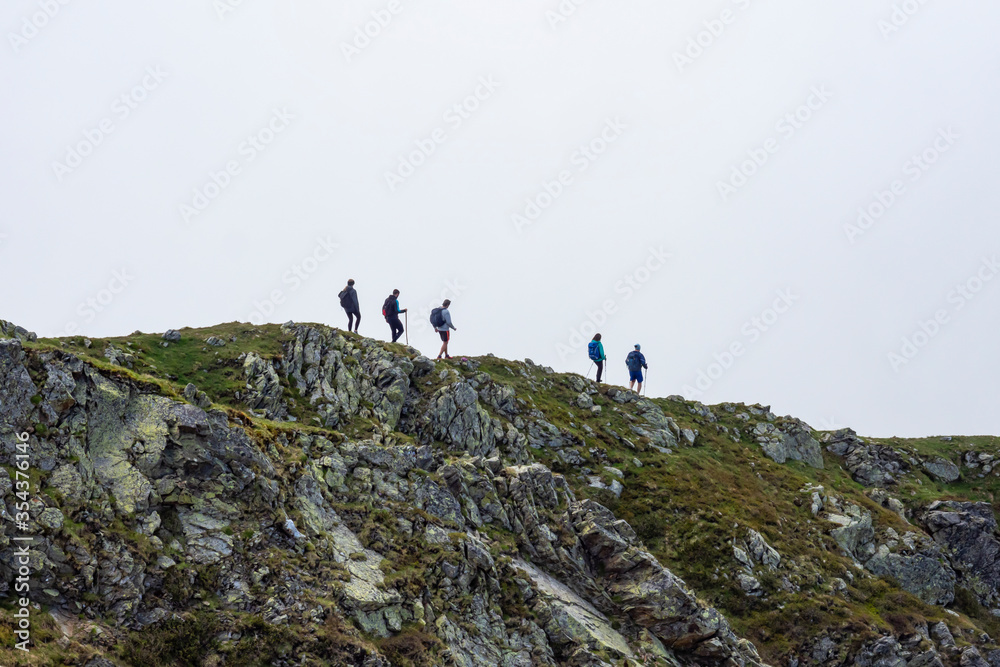 Trekking scene in a foggy day in the alps