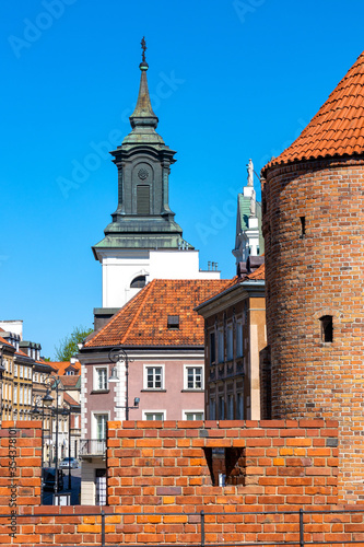 Warsaw Barbican fortified outpost as part of brick and stone historic defence walls with Stare Miasto Old Town quarter in background in Warsaw, Poland photo