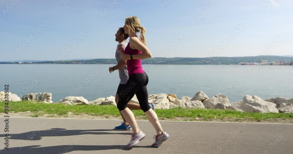 4K Tracking Slow Motion Of Couple Competing And Running To Finishing Line