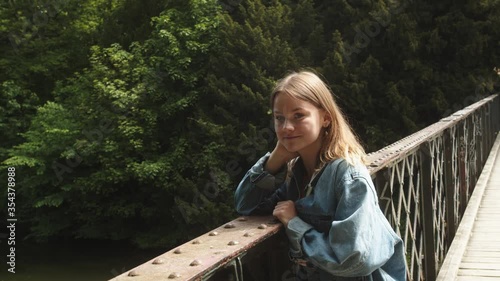 Young Girl on a Romantic Date Outside in a Park Looking at you with Flirt and Smiling.