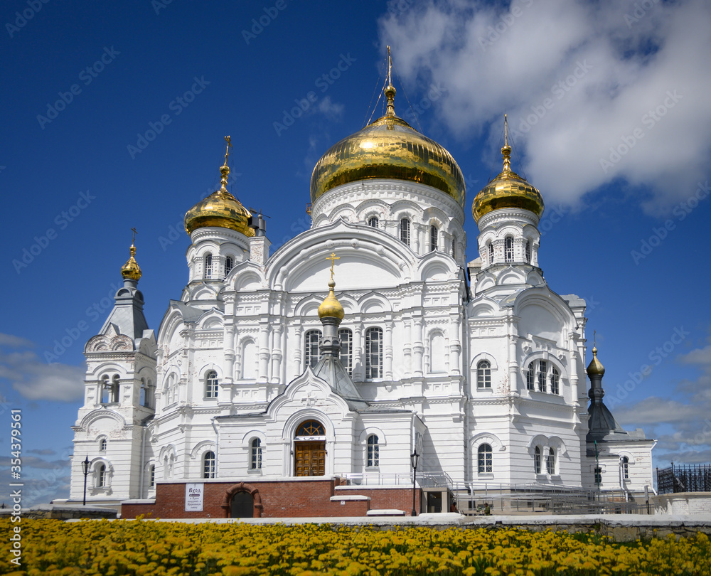 Belogorsk monastery, Perm, Russia with yellow flowers