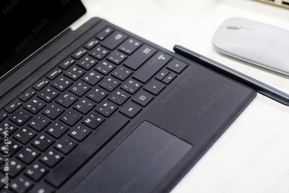 Black keyboard laptop pen and mouse on workspace at home , work from home with modern business digital communication Black keyboard laptop pen and mouse on workspace at home , work from home with modern business digital communication