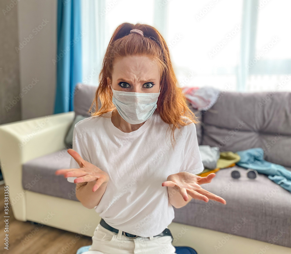 Cute girl in a medical mask is waiting for the end of the pandemic, the girl is planning a vacation, rest after the pandemic.