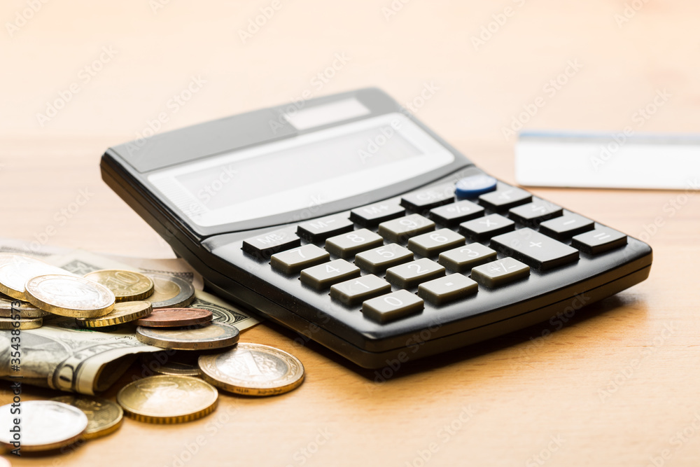 Coin money and banknote bills with a calculator. ballance reduction Coin money and banknote bills with a calculator. ballance reduction