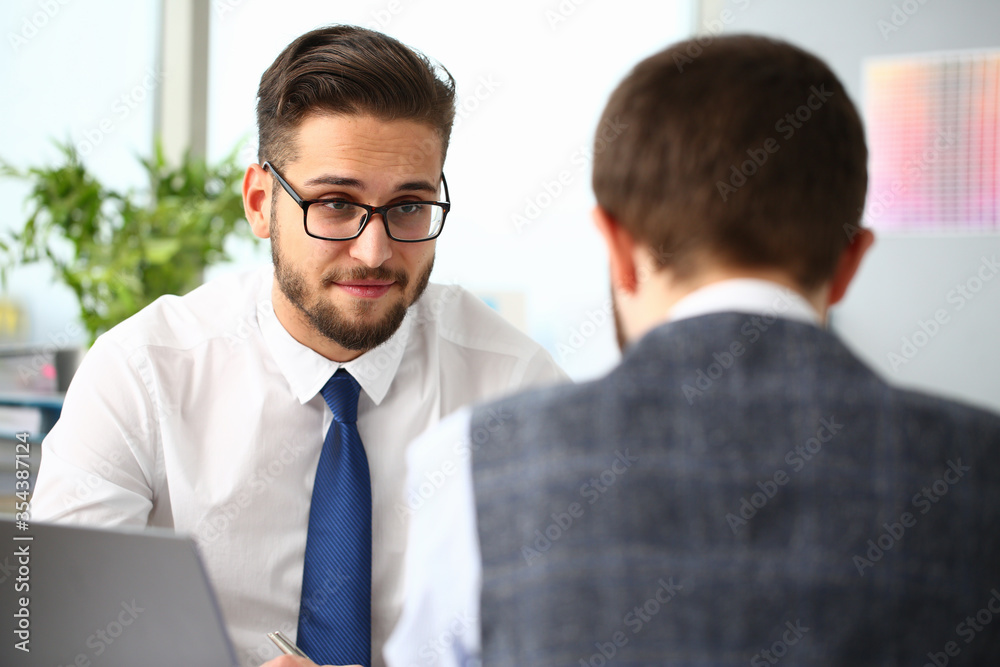 Two young managers discussing their business plan Two young managers discussing their business plan
