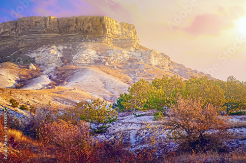 an amazingly beautiful landscape with mountain canyons, rocky terrain and colorful beautiful sky at sunset