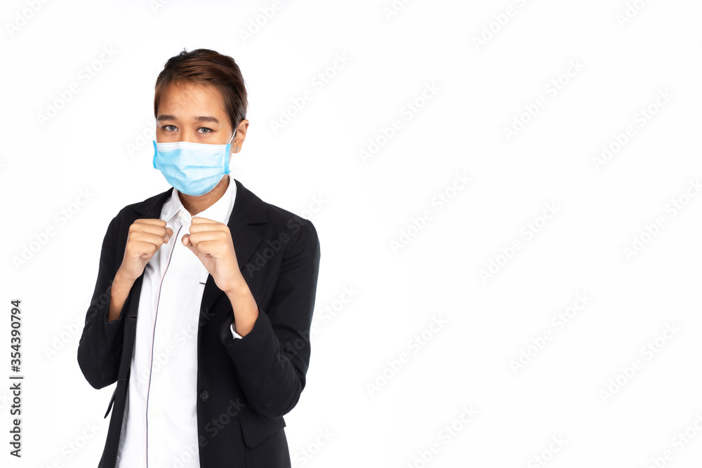 Asian businesswoman wearing surgical face mask in formal black suit jacket, looking at camera, boxing posture, fighting, studio lighting isolated on white background, coronavirus, COVID19 concept Asian businesswoman wearing surgical face mask in formal black suit jacket, looking at camera, boxing posture, fighting, studio lighting isolated on white background, coronavirus, COVID19 concept