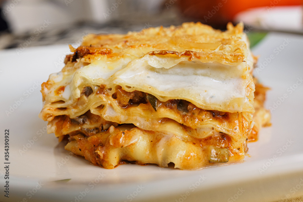 Portion of Italian lasagna stuffed with meat and vegetables