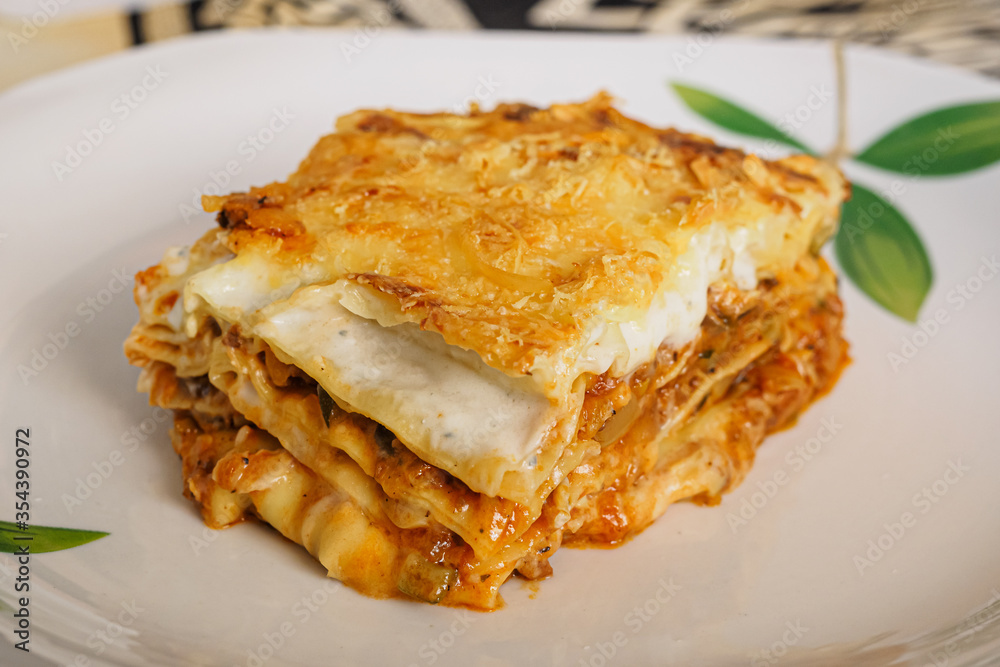 Portion of Italian lasagna stuffed with meat and vegetables Portion of Italian lasagna stuffed with meat and vegetables