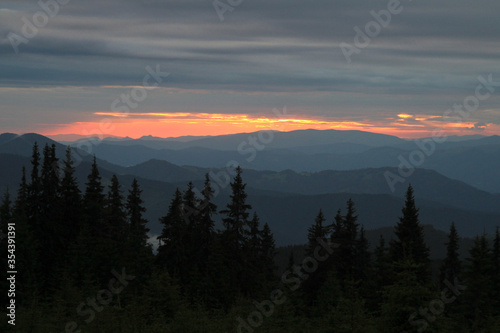 Majestic sunset in the mountains landscape with sunny beams. Dramatic scene. Hiking travel outdoor concept. Carpathians, Ukraine