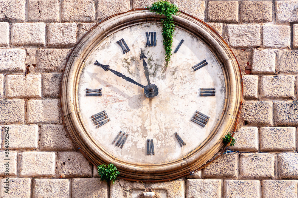 Close view in details of an ancient tower clock, old medieval town of Kotor, Montenegro