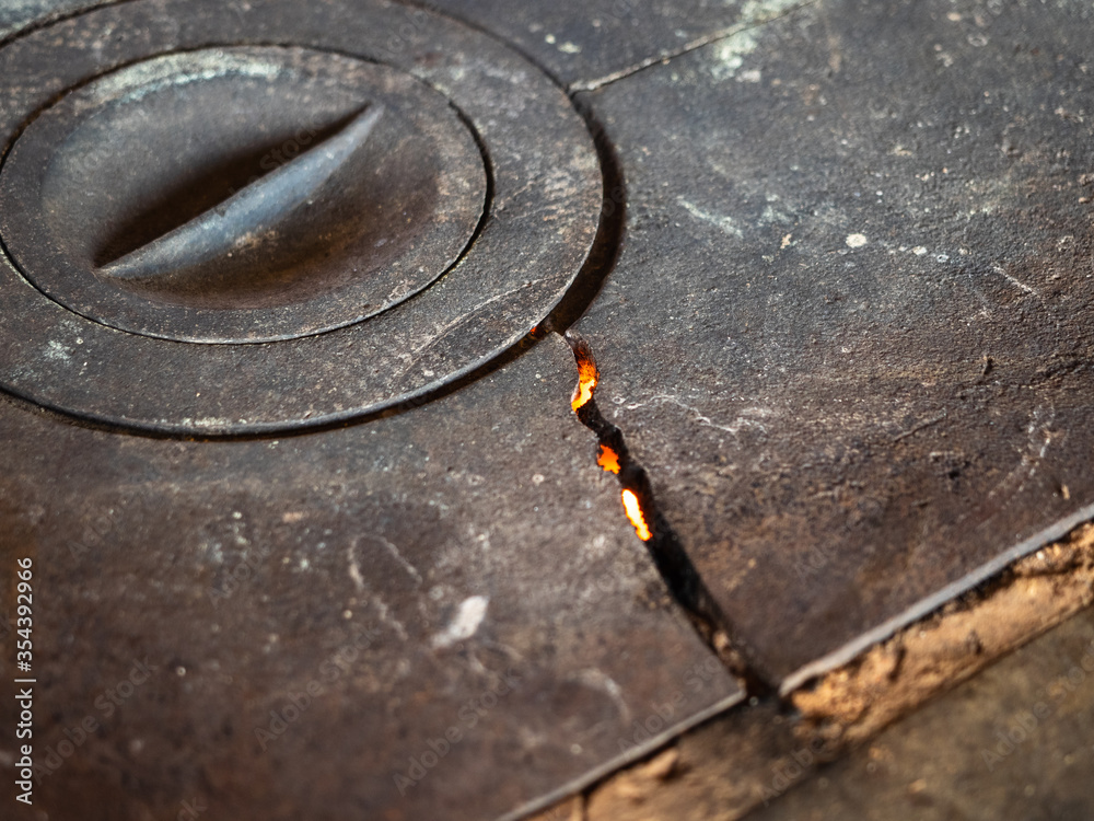 Old rusty metal plate with a crack. Wood-burning stove for cooking. Cozy atmosphere Old rusty metal plate with a crack. Wood-burning stove for cooking. Cozy atmosphere