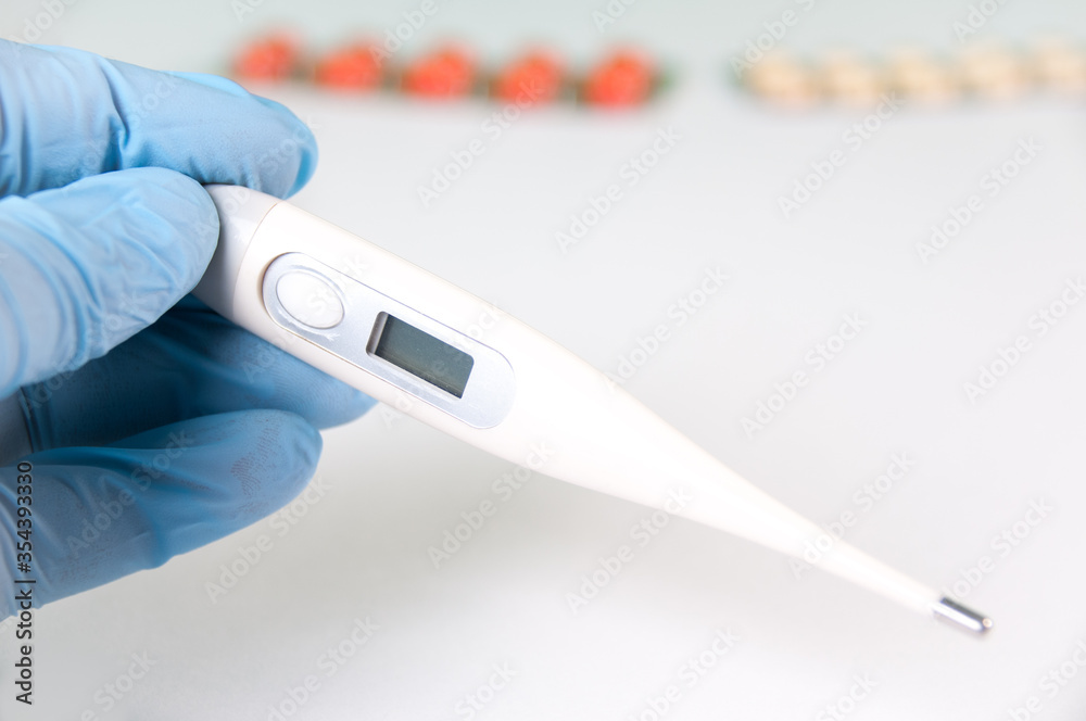 Obraz premium Tablets And A Protective Blue Mask Lie On A White Background