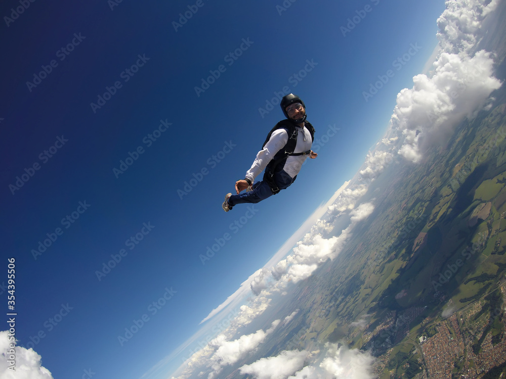 Skydiver jumping free with the clouds. Skydiver jumping free with the clouds.
