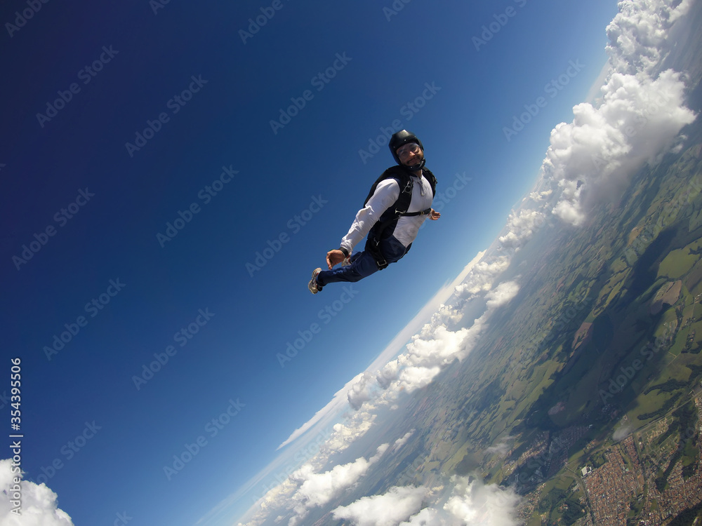 Skydiver jumping free with the clouds.