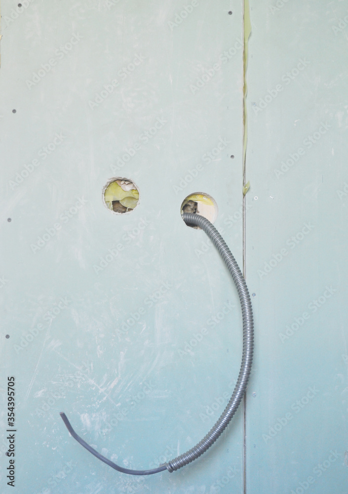 Running electrical cable, wires in metal conduit through walls, cutting