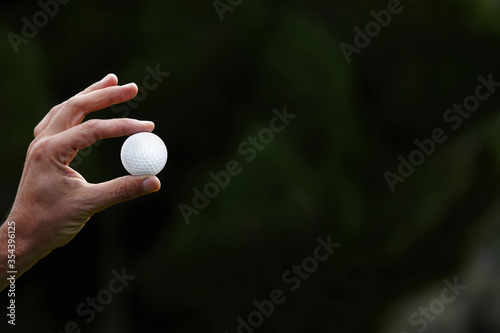 close up, golf player holding golf ball with big copy space for your text message