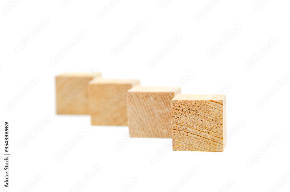 Wooden cubes on a white background. Four identical cubes lie, stand in a row along the diagonal Wooden cubes on a white background. Four identical cubes lie, stand in a row along the diagonal