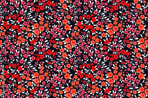 Vintage floral background. Seamless vector pattern for design and fashion prints. Flowers pattern with small orange and red flowers on a dark blue background. Ditsy style.