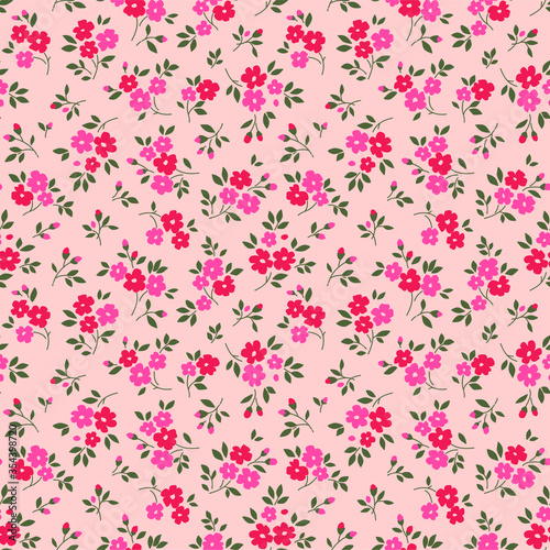 Vintage floral background. Seamless vector pattern for design and fashion prints. Flowers pattern with small pink and red flowers on a pale pink background. Ditsy style.