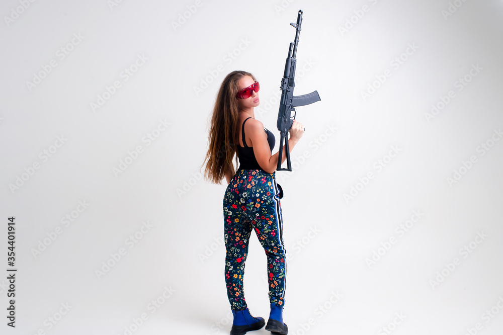 Strong young woman with a gun, picture isolated on white background Strong young woman with a gun, picture isolated on white background