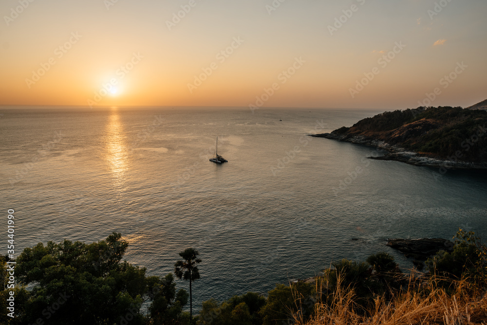 Fototapeta premium Thailand, 2020: drone shot from above, panoramic ocean view on sunset with trees and cliffs