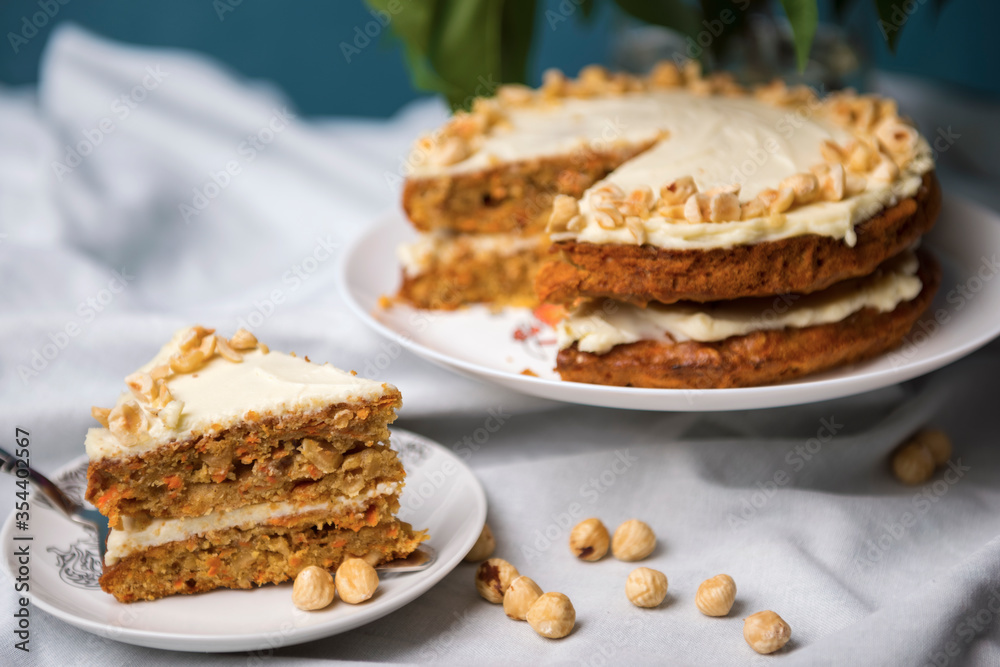 Piece of carrot cake with carrot cake on the background Piece of carrot cake with carrot cake on the background