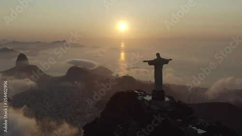 Drone, aerial footage of a silhouette of Christ the Redeemer over morning clouds in the summer Rio de Janeiro Brazil