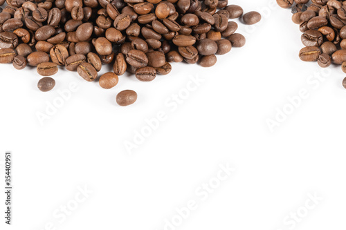 Roasted coffee beans on a white background. Place for text.