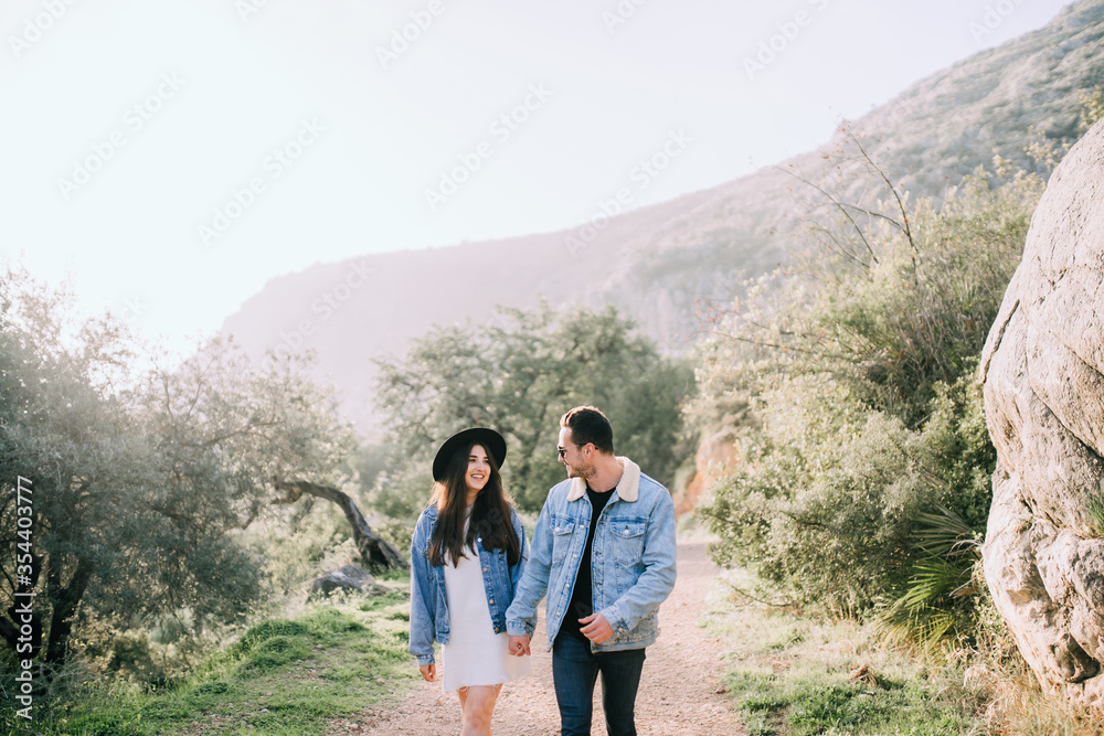 young couple walking in the mountains