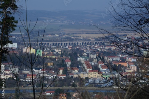 Aerial shot of a city with a river, a bridge surrounded by high hills photo