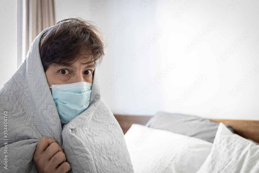 a sick man, with a blanket over his back