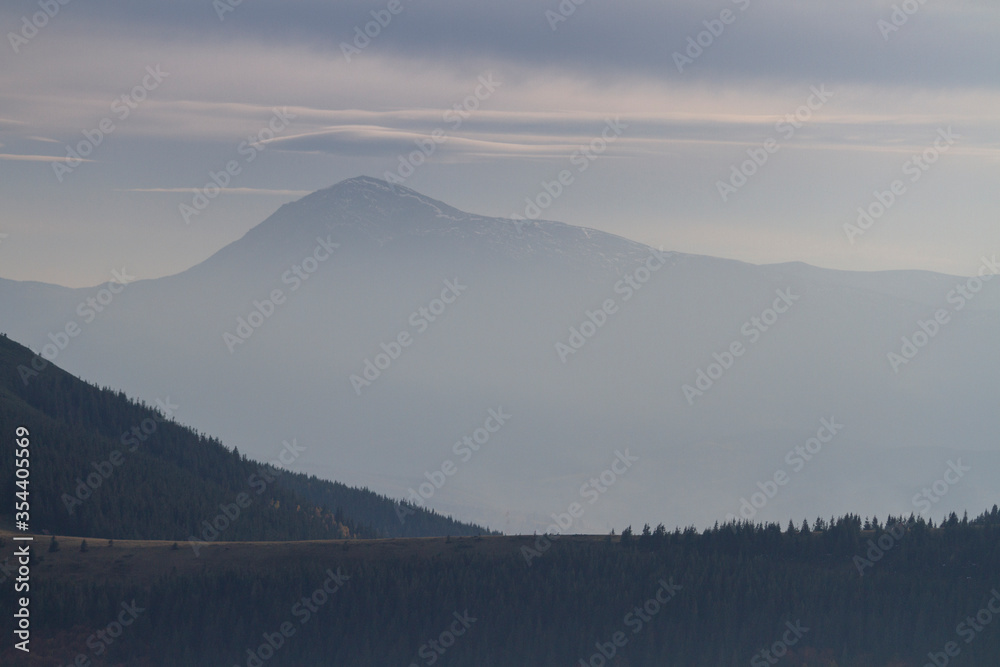 Mountain forest in the fog. Hiking travel outdoor concept panoramic view. Ukrainian Carpathian Mountains, Ukraine
