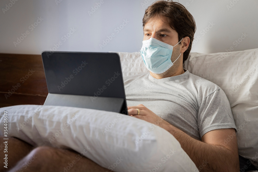 Man working in bed, doing home office because he is sick. Man working in bed, doing home office because he is sick.