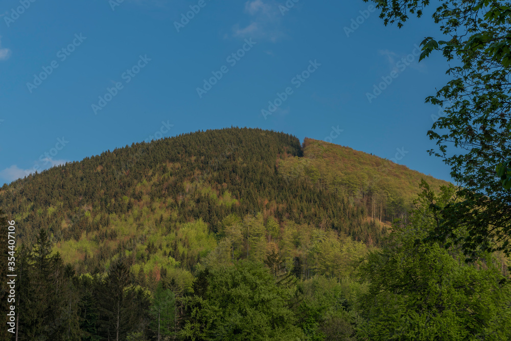 Hills over Trojanovice village in spring sunny color evening