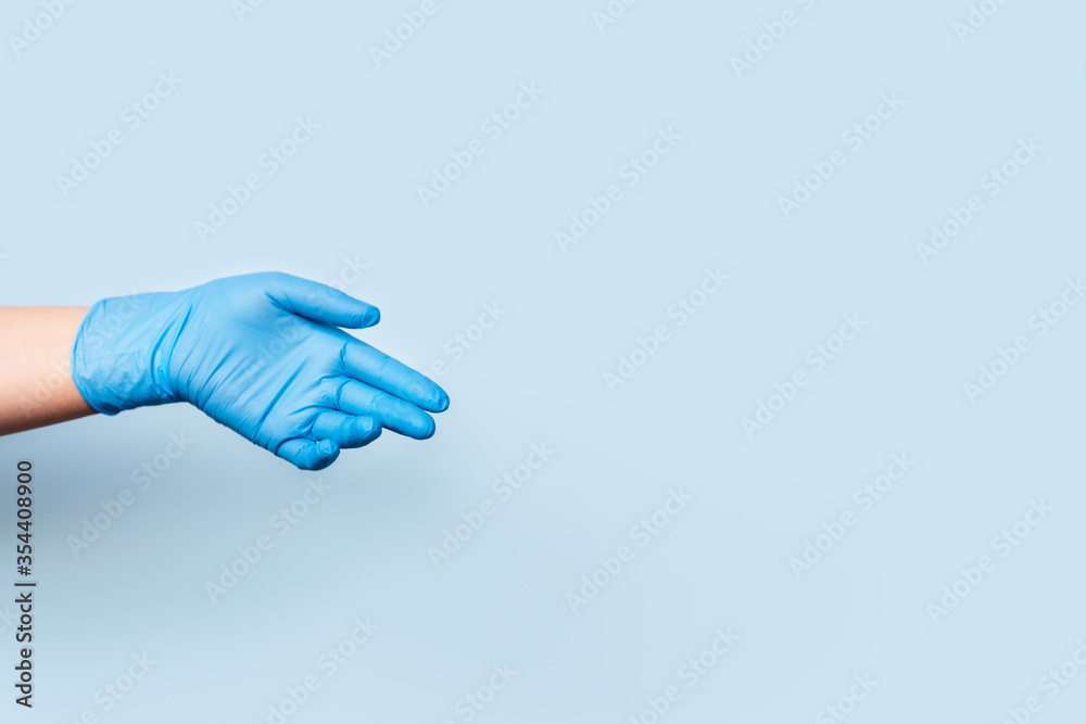 Photo on the spread of diseases in the world. The hand in the blue medical glove is sadly lowered down. Photo on the spread of diseases in the world. The hand in the blue medical glove is sadly lowered down.