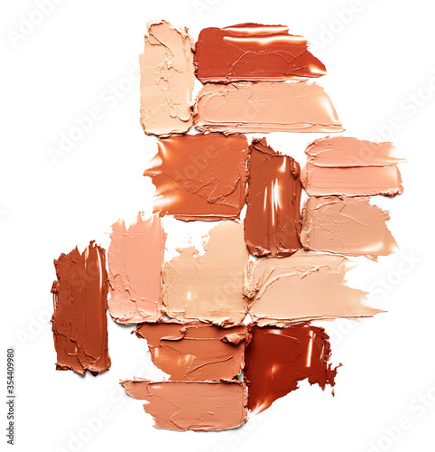 Smudged makeup foundation isolated on white background photo