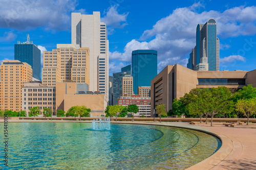 Downtown Dallas buildings line a refreshing fountain courtyard rest area.