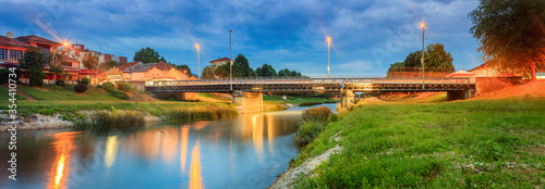 Panoramic view of central bridge in Pirot, Serbia, called Golemi most over river Nisava during late blue hour photo