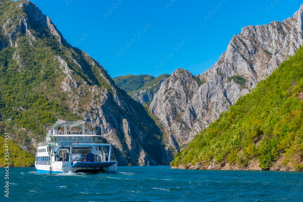 Ferry cruising lake Koman in Albania Photos | Adobe Stock