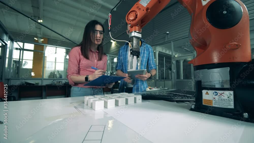 Robotic claw is relocating objects under control of the researchers