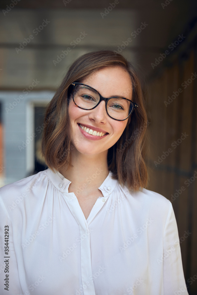 Portrait of smiling young business woman with glasses Portrait of smiling young business woman with glasses