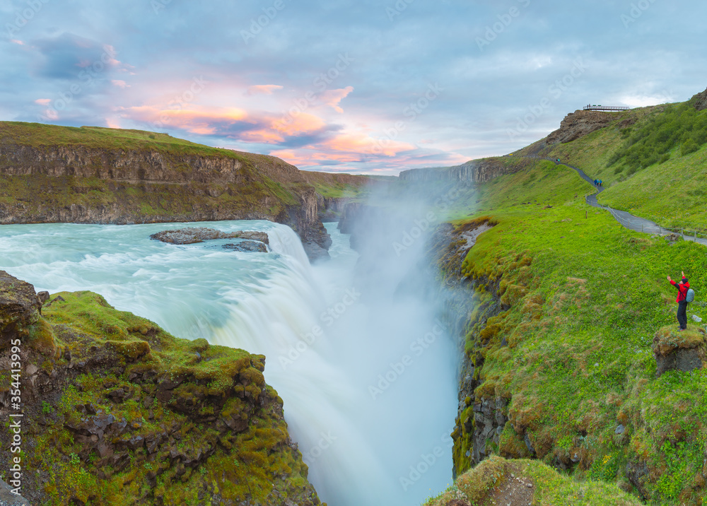 Amazing summer sunrise on Gullfoss Waterfall.
A man enjoys a view of a waterfall standing on a cliff. Colorful morning scene of Iceland. Midnight sun of Iceland. Visit Iceland. Beauty world. Amazing summer sunrise on Gullfoss Waterfall.
A man enjoys a view of a waterfall standing on a cliff. Colorful morning scene of Iceland. Midnight sun of Iceland. Visit Iceland. Beauty world.