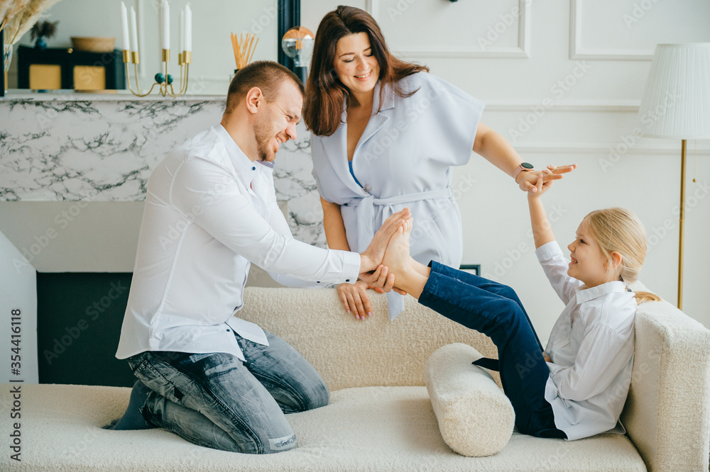 Cheerful parents plays with their child at home Cheerful parents plays with their child at home
